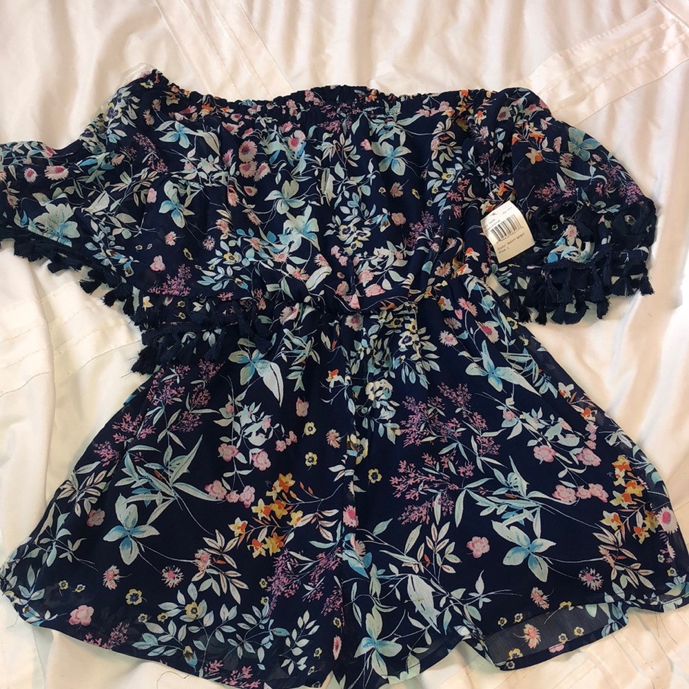 Never worn. Romper off shoulder with tassels.